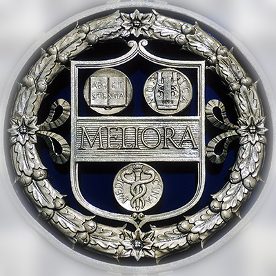 A close up detail of metal scroll work with the word Meliora in the center.