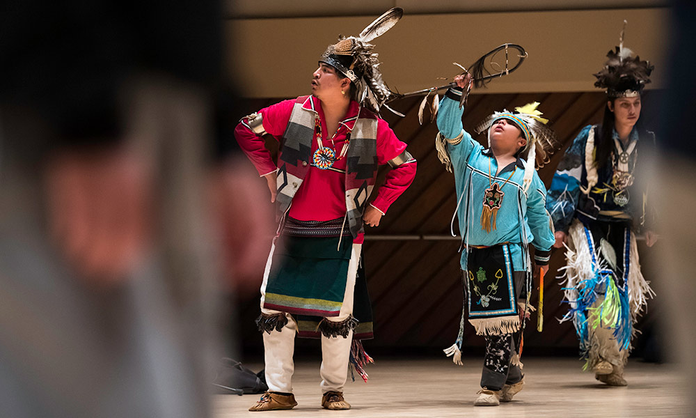 Members of the Seneca Nation’s Allegany River Indian Dancers (L-R) Jacob Dowdy, Liam Dowdy, and Dylan Harris perform in the May Room of Wilson Commons as part of UR Remnants.