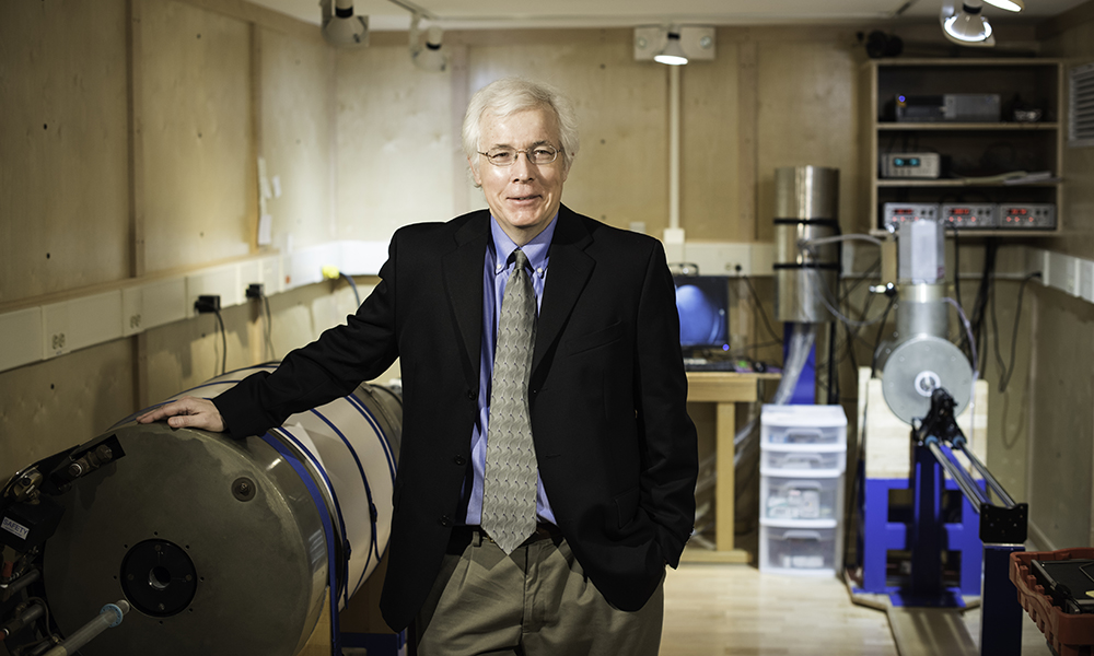 Professor Tarduno posing with equipment in a lab.