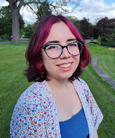 A headshot of Sydney smiling at the camera.