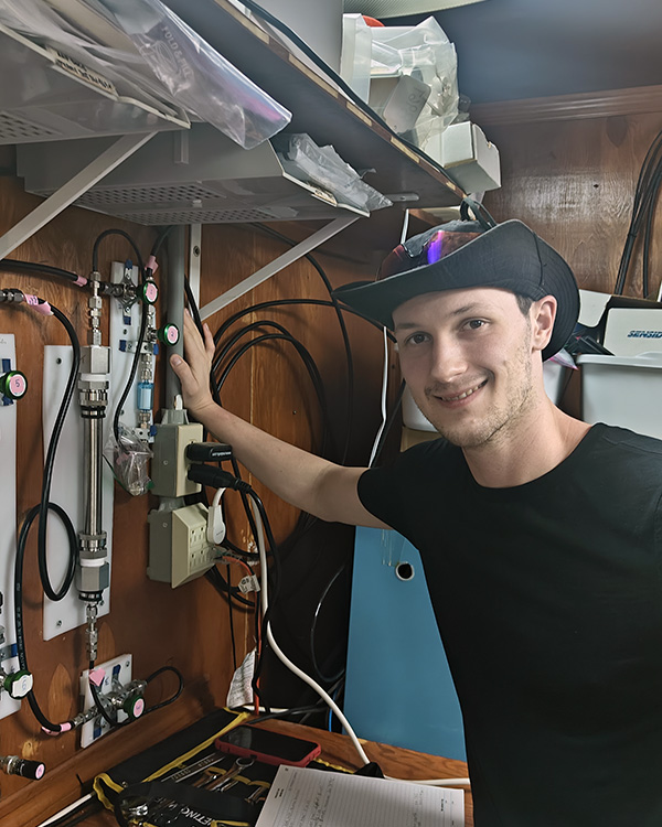 Sebastian working in the lab with an open flame.