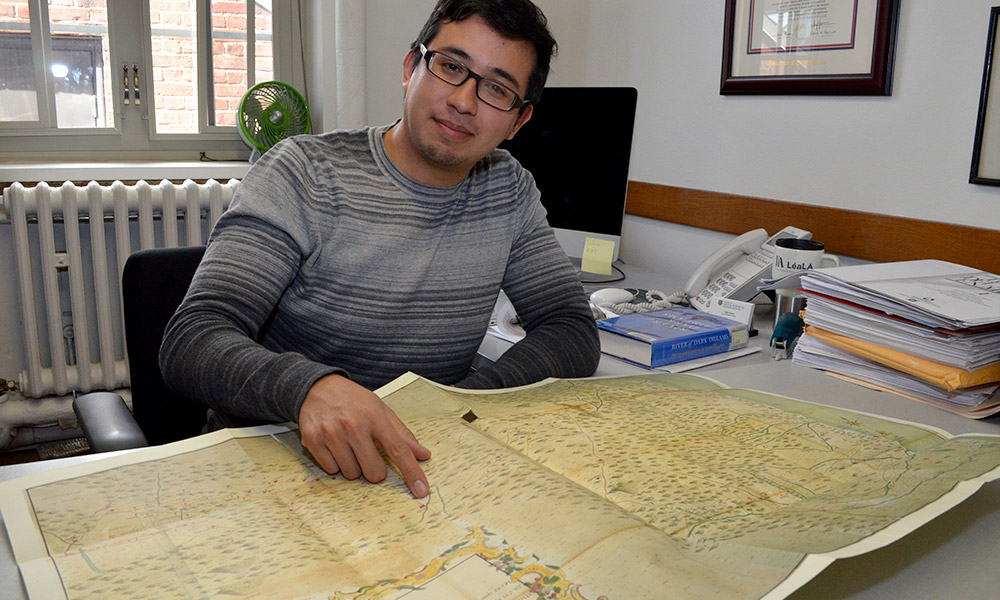 An assistant professor of history, points to a route African captives were transported along in colonial Mexico.