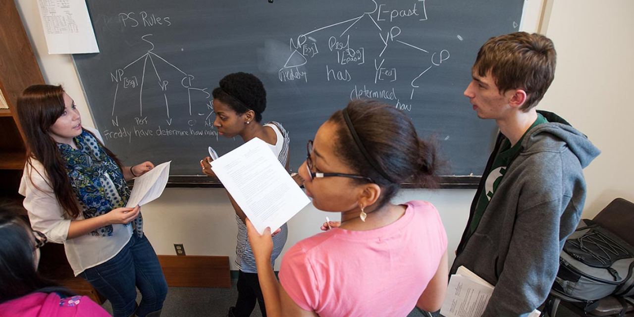 Students working at a blackboard.