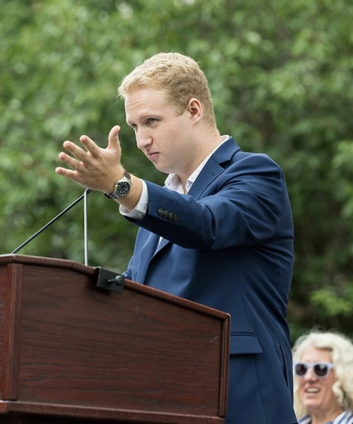 Elijah Bader-Gregory giving a speech from a podium.