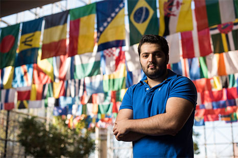 Student in front of flags