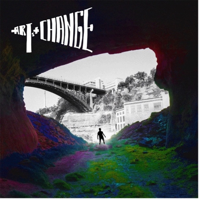 A man waling through a tunnel towards a bridge.