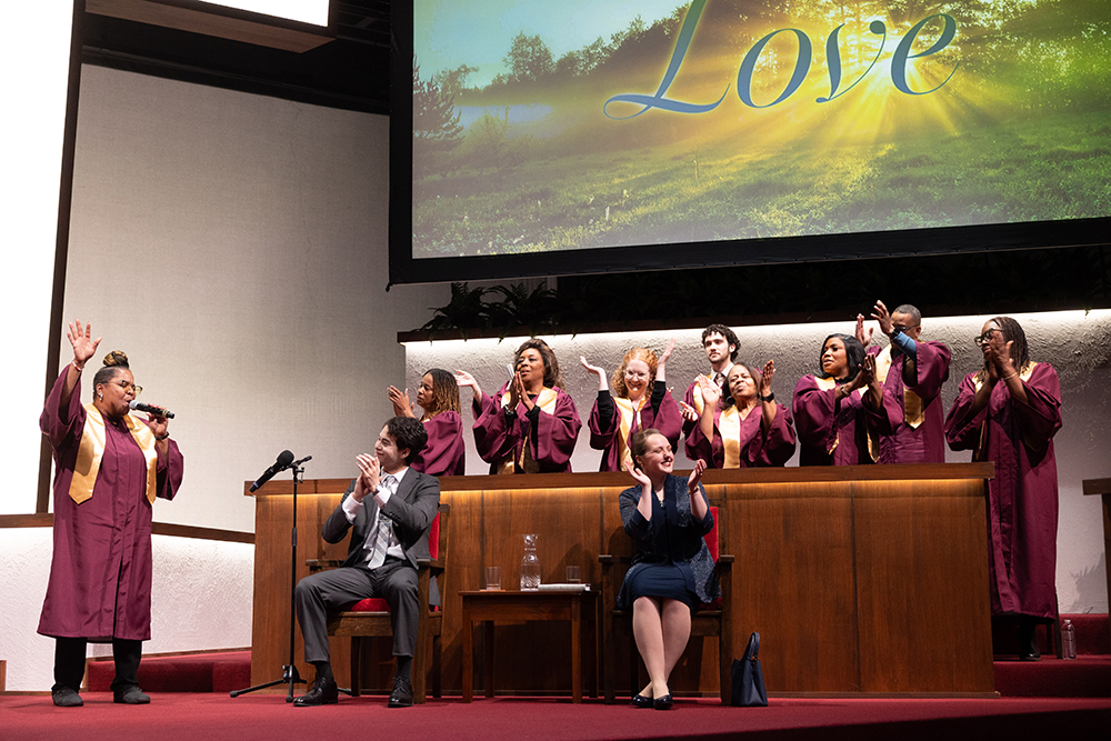 Church choir singing as two people clap along.