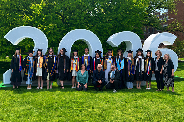 A group photo of faculty and students at commencement.
