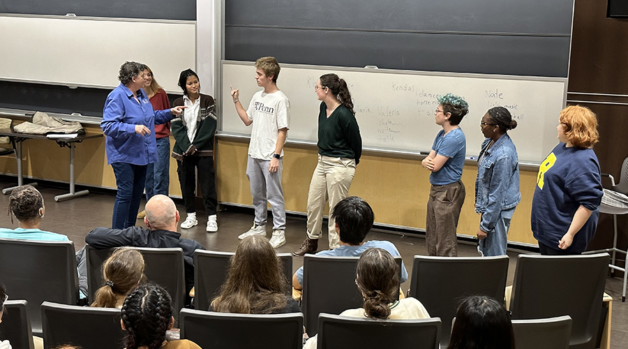 Students, faculty, and staff at an event with a guest speaker.