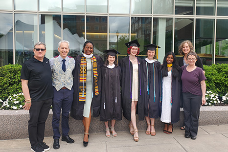 A group photo of faculty and students at commencement.