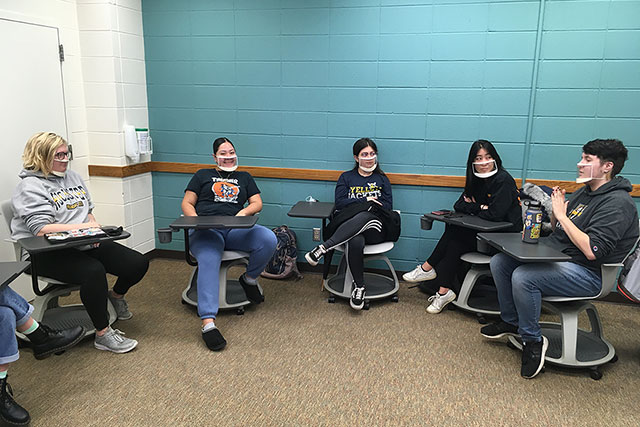 Five students having a discussion.
