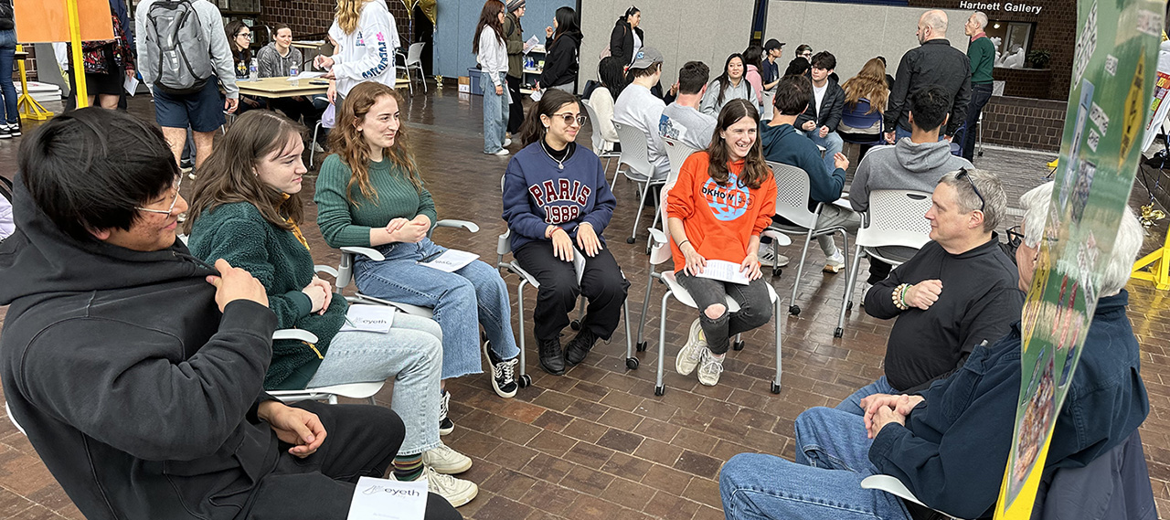 Students involved in an Eyeth Day activity sitting in a circle.