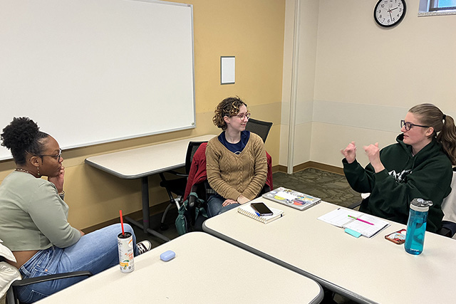 Three students having a discussion.