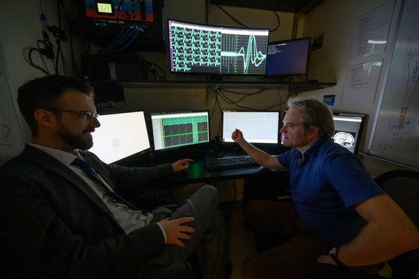 Snyder (left) and Haefner sitting at computers in a lab at the University of Rochester