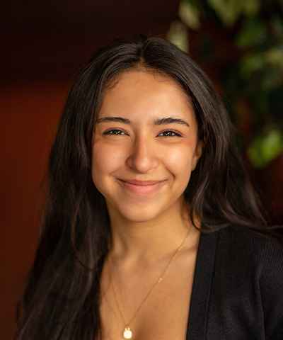 Headshot of Kirya Caine.