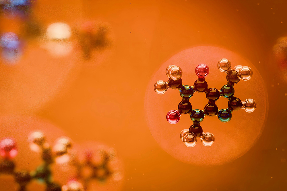 Molecular structures against an orange background.