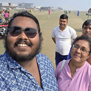 Abhishek taking a selfie with friends in the background.