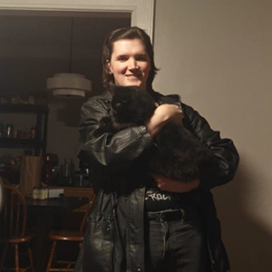 Chloe holding a black cat.