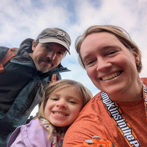 A selfie of Jeff with his wife and child.