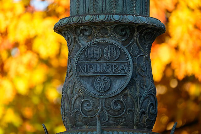 A close up of an engraving of Melinda on a campus light pole.