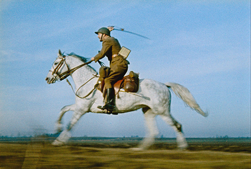 A still image from the film of a woman confronting a man on a horse.