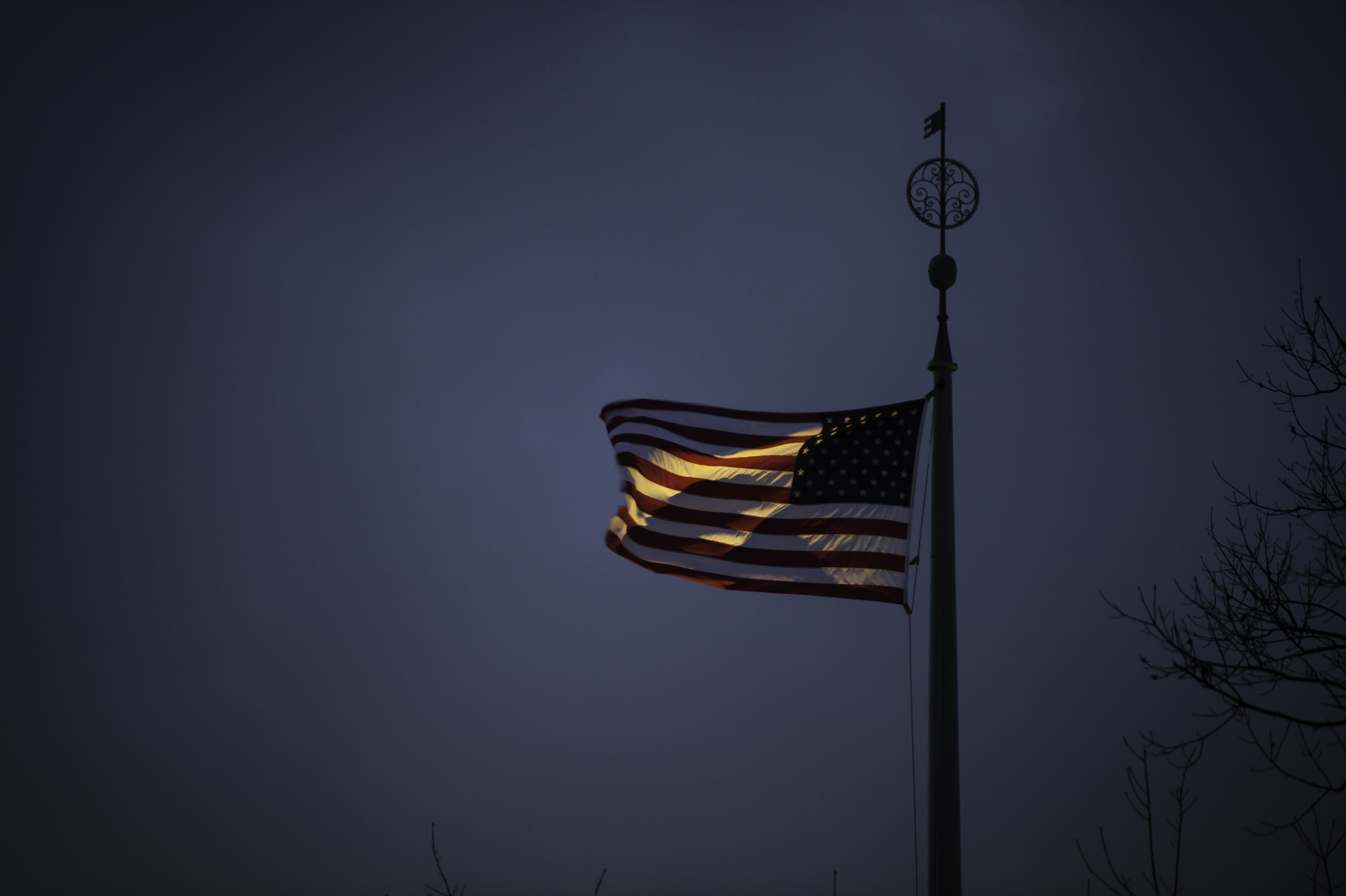 American flag on the University of Rochester River Campus at twilight.
