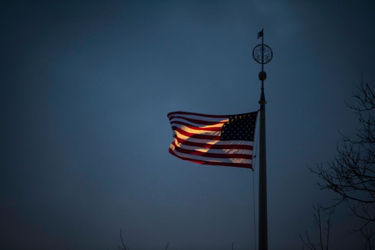 An American flag dappled with sunlight