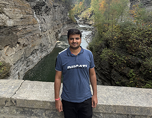 Yadav standing on a stone bridge.