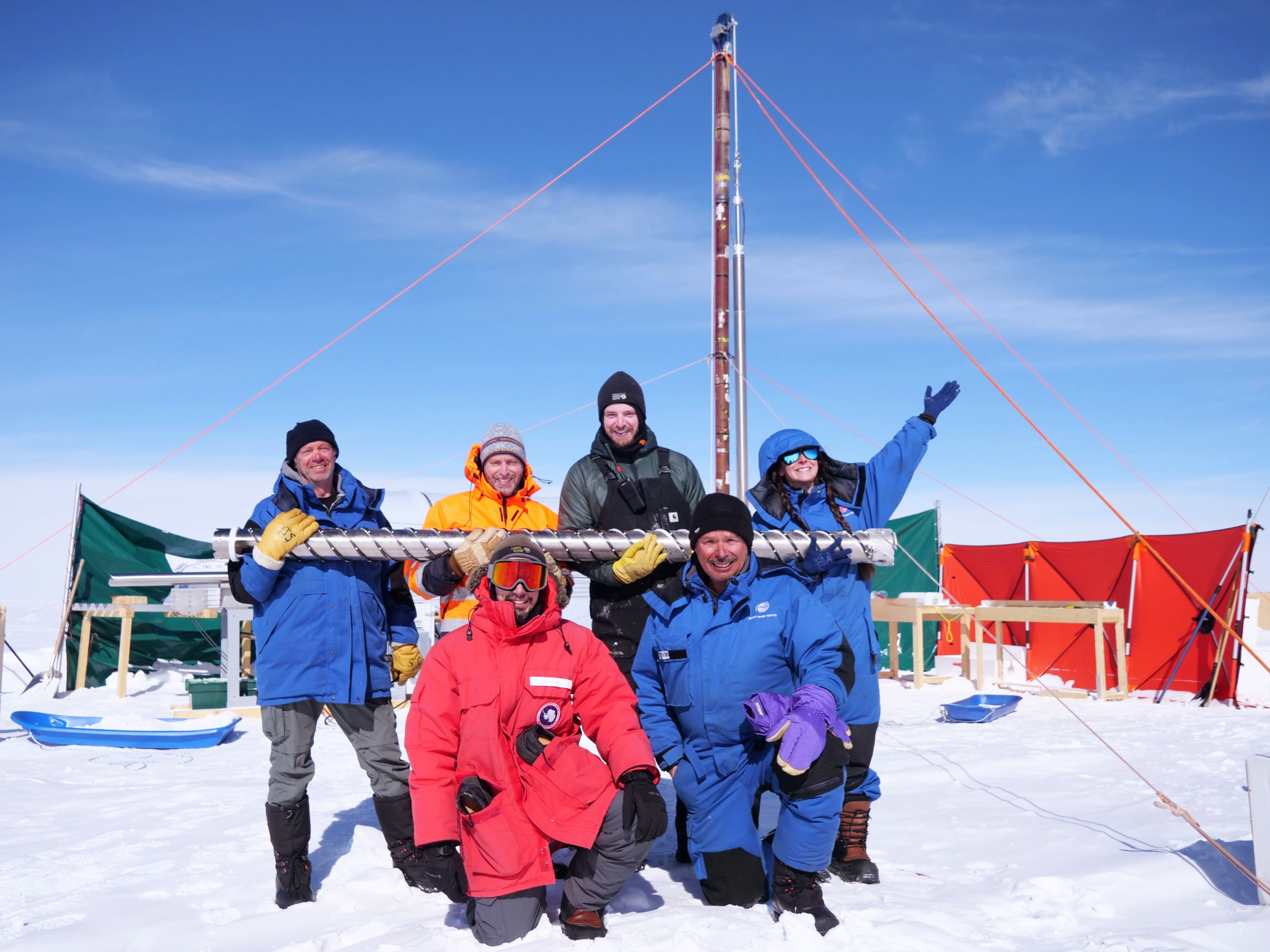 science team posing with the drill barrel