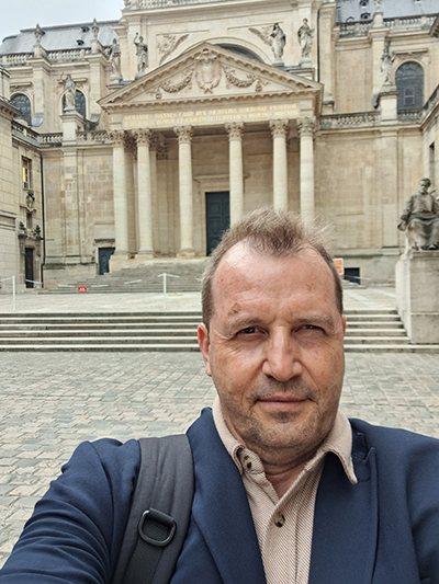 Doran taking a selfie in front of an historical building.