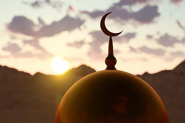The top of an Islamic temple at sundown.